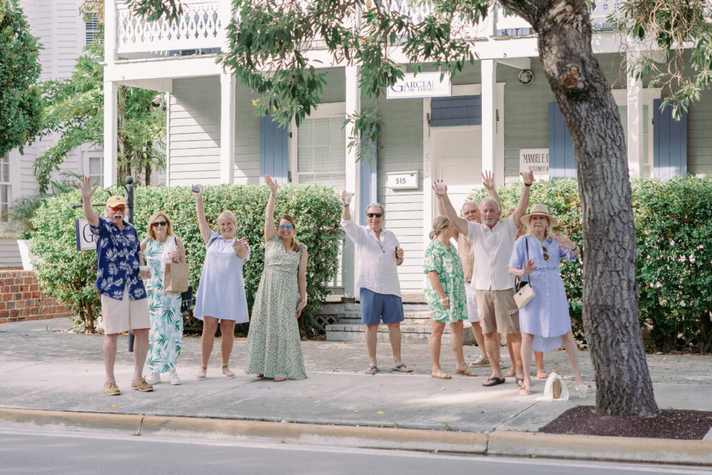 People waving at bride and groom 