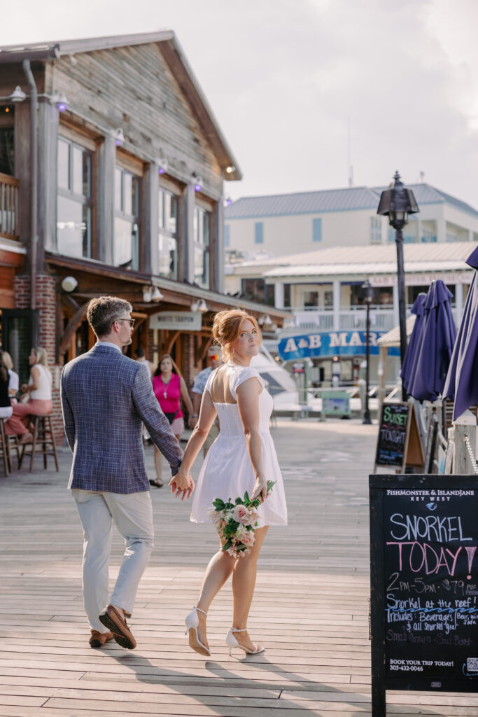 couple holding hands in the Garrison Bight Marina 