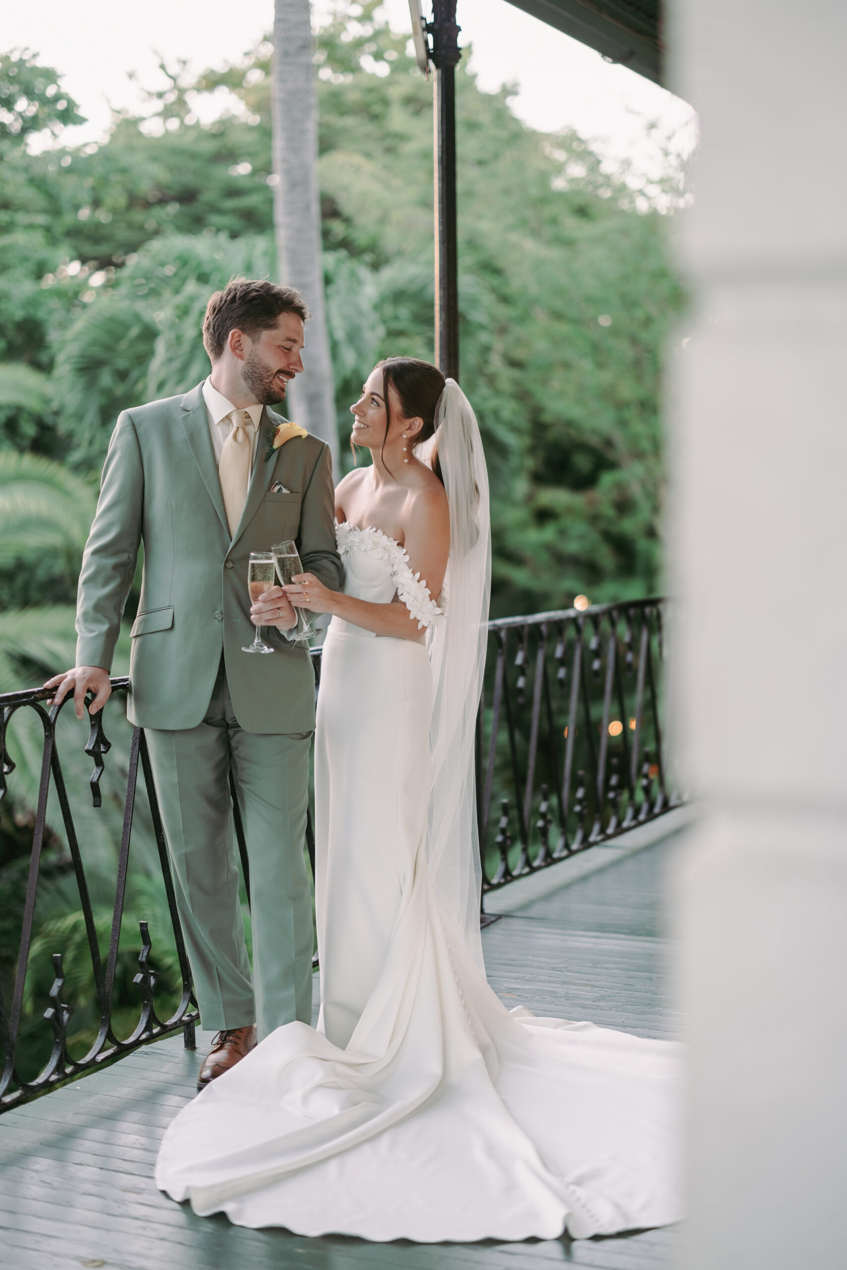 Couple having a toast at their dream wedding at the Hemingway House Museum.