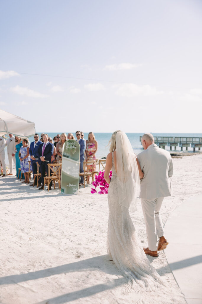 Bride walking toward the altar at a beachfront Casa Marina ceremony