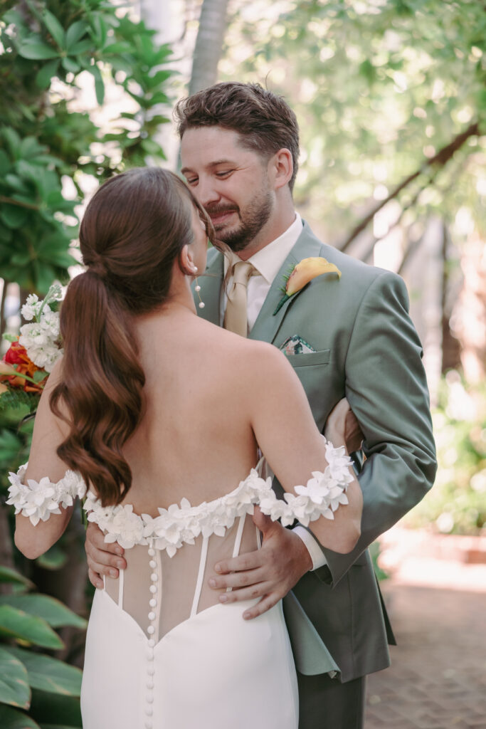 Couple’s first look at their dream wedding at the Hemingway House Museum, capturing an unforgettable moment.