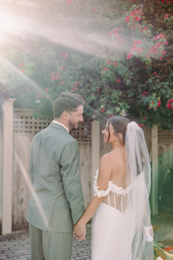 Couple sharing a tender moment, gazing at each other during their dream wedding at the Hemingway House Museum, capturing a serene and intimate atmosphere.