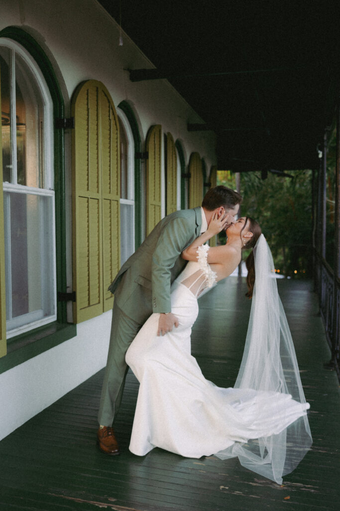 Couple sharing a kiss at the Hemingway House Museum, capturing a serene and intimate moment.