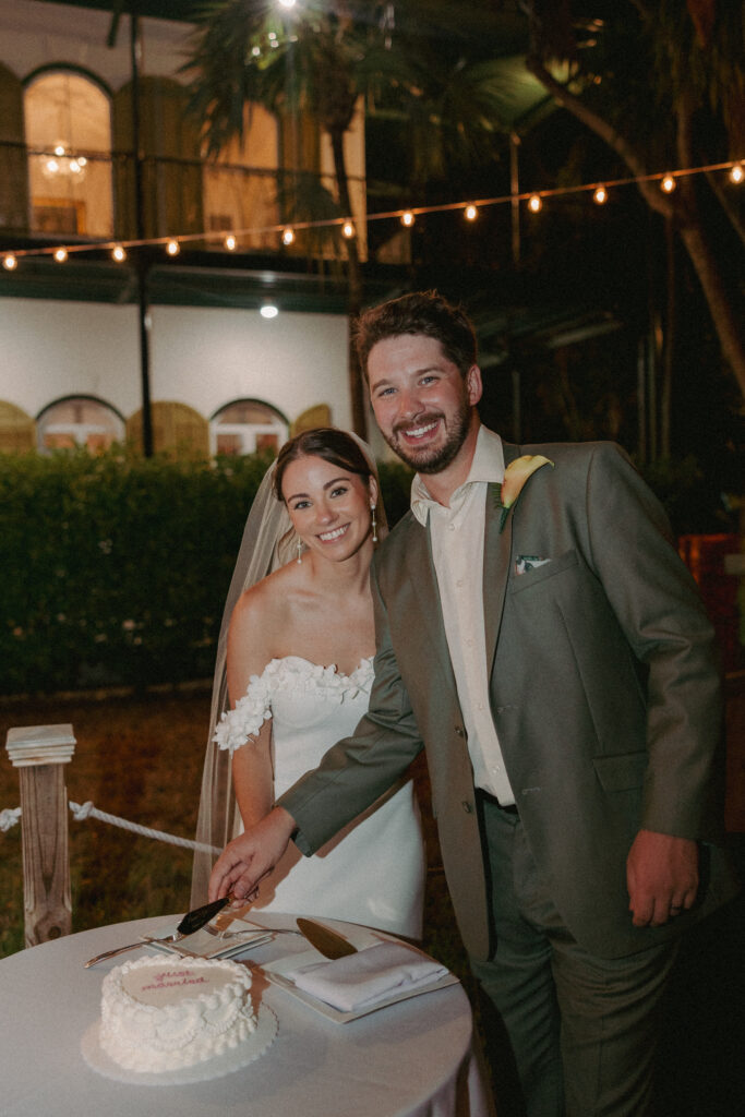 Couple slicing the cake at their dream wedding at the Hemingway House Museum, marking a sweet and memorable moment.