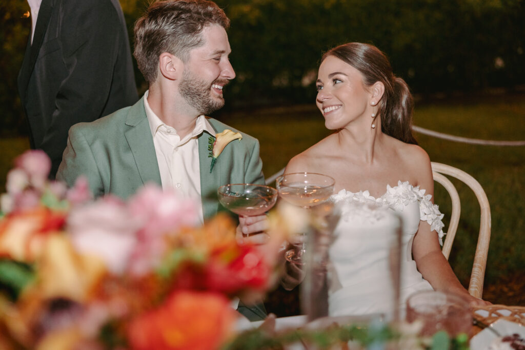 Couple gazing at each other during their wedding reception at their dream wedding at the Hemingway House Museum, marking a sweet and memorable moment.