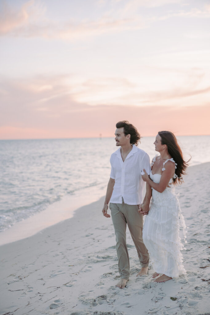 Couple strolling hand in hand along the shore during their Lifestyle Session in the Florida Keys.