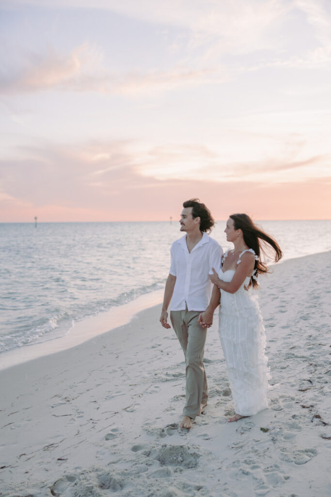 Couple strolling hand in hand along the shore during their Lifestyle Session in the Florida Keys.