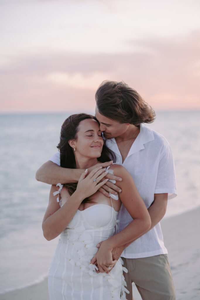 Couple embracing by the beach with a back hug during their Lifestyle Session in the Florida Keys.