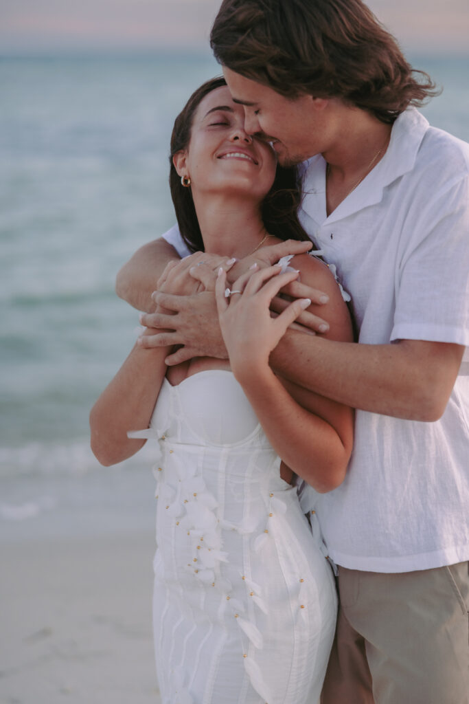 Couple embracing by the beach with a back hug during their Lifestyle Session in the Florida Keys.