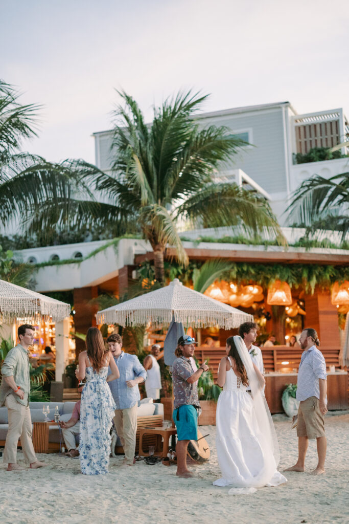 Guests mingle on the beach outside a Cruz Bay villa during a St John USVI wedding