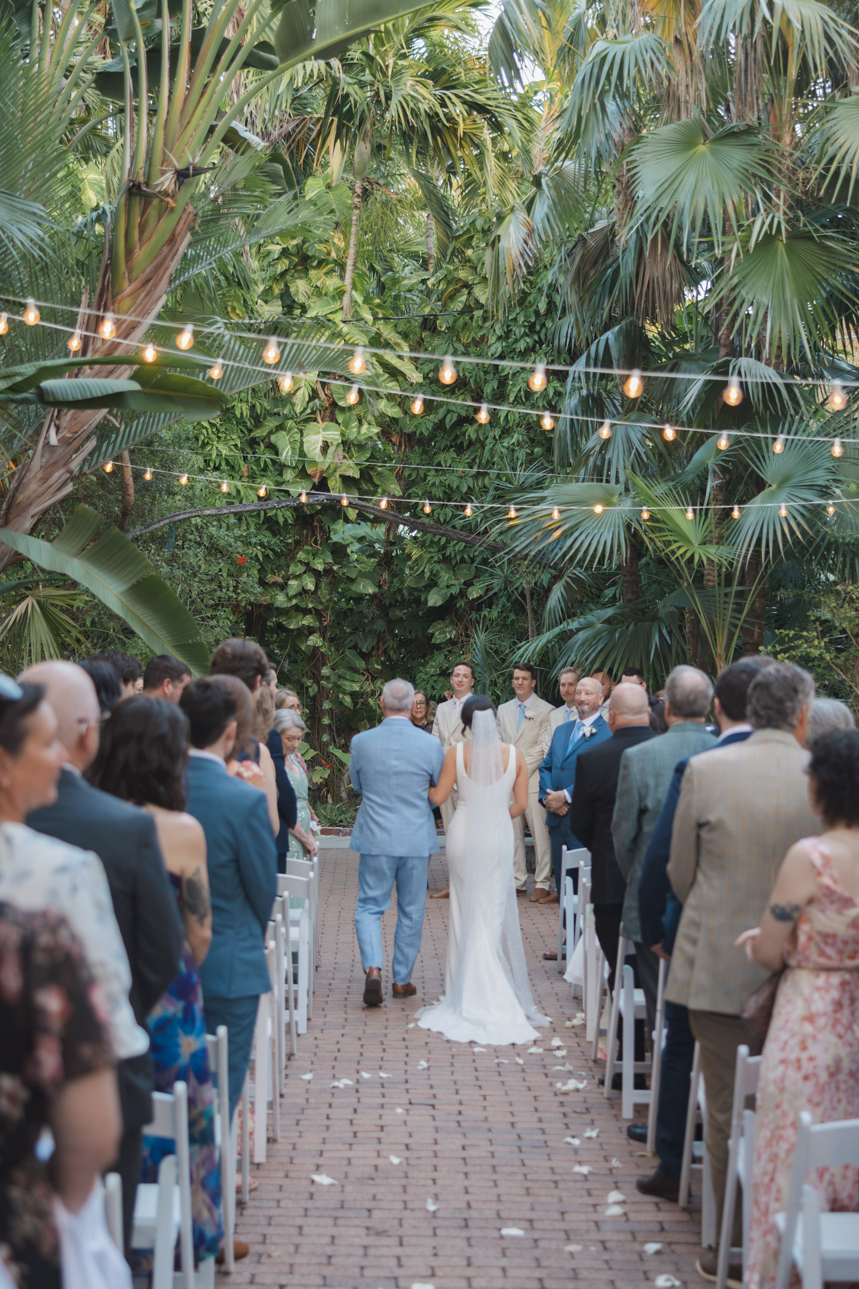 Father walking bride down the aisle in the garden of the Hemingway House wedding venue