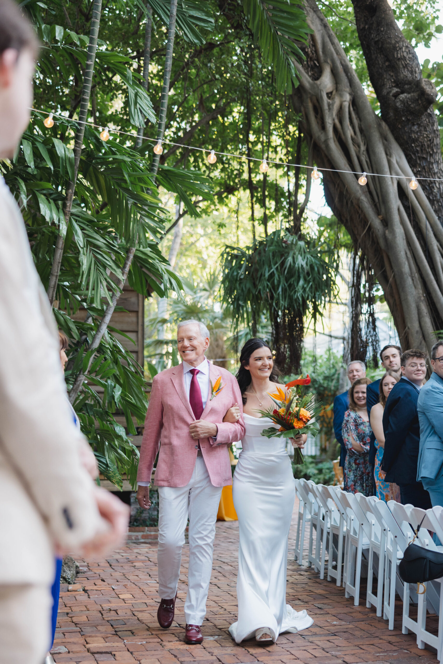 Father walking his daughter down the aisle at the Audubon House garden, Key West