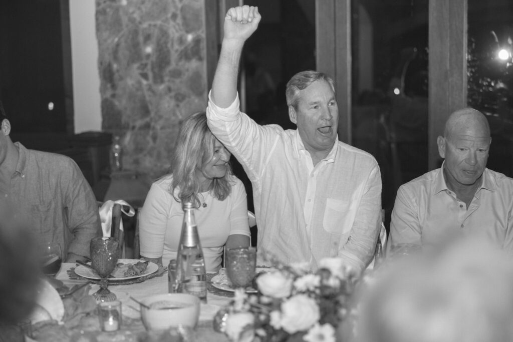 Wedding guest cheers during the reception