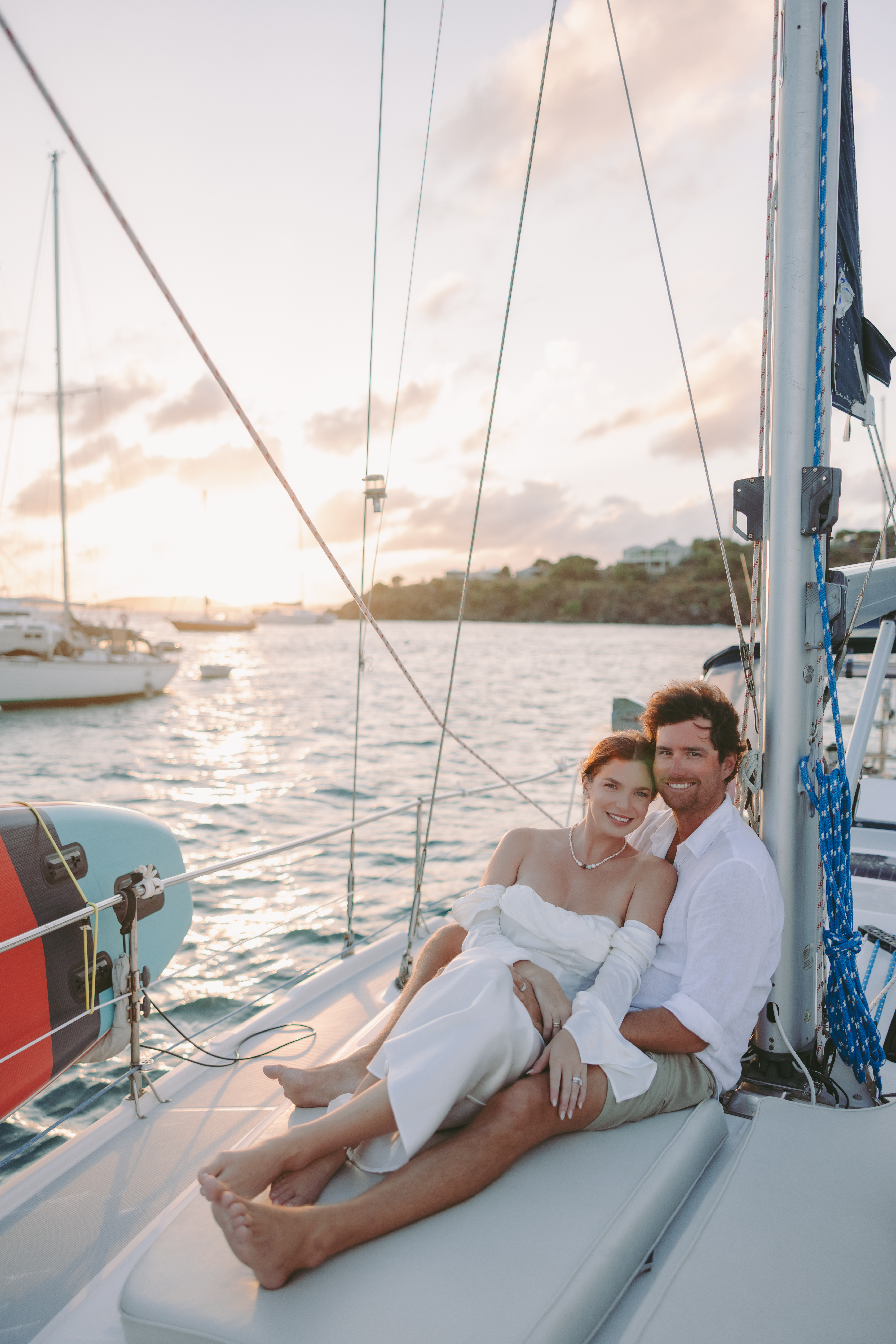 Couple on the back of their sailboat while the sunsets after their St John USVI wedding
