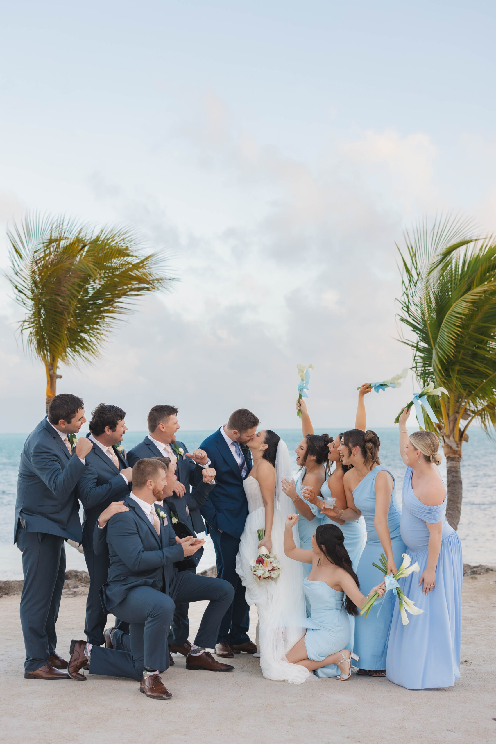 Bride and groom with their wedding party on the beach during their Cheeca Lodge wedding ceremony