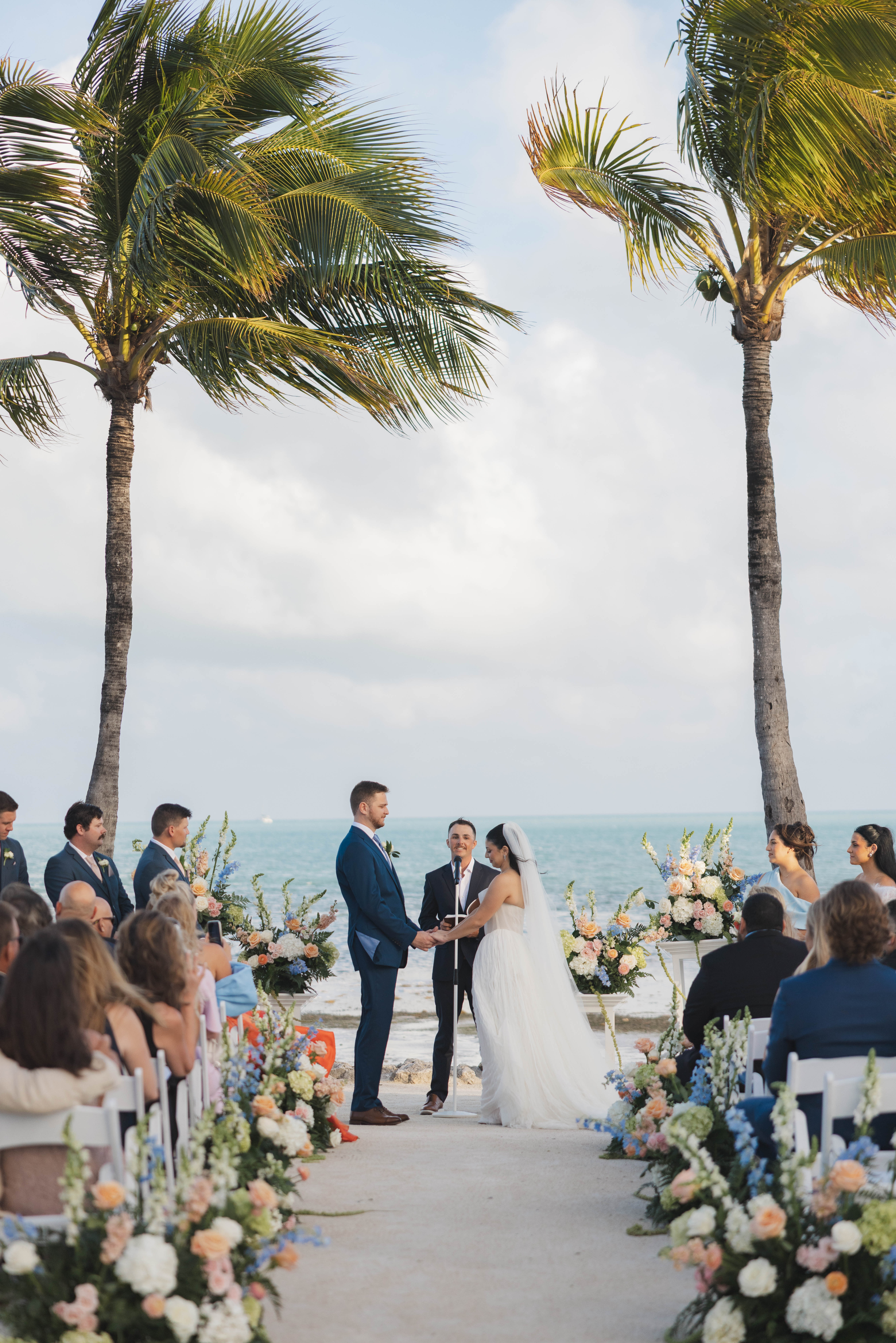 Bride and groom exchanging vows on the beach during their Cheeca Lodge wedding ceremony