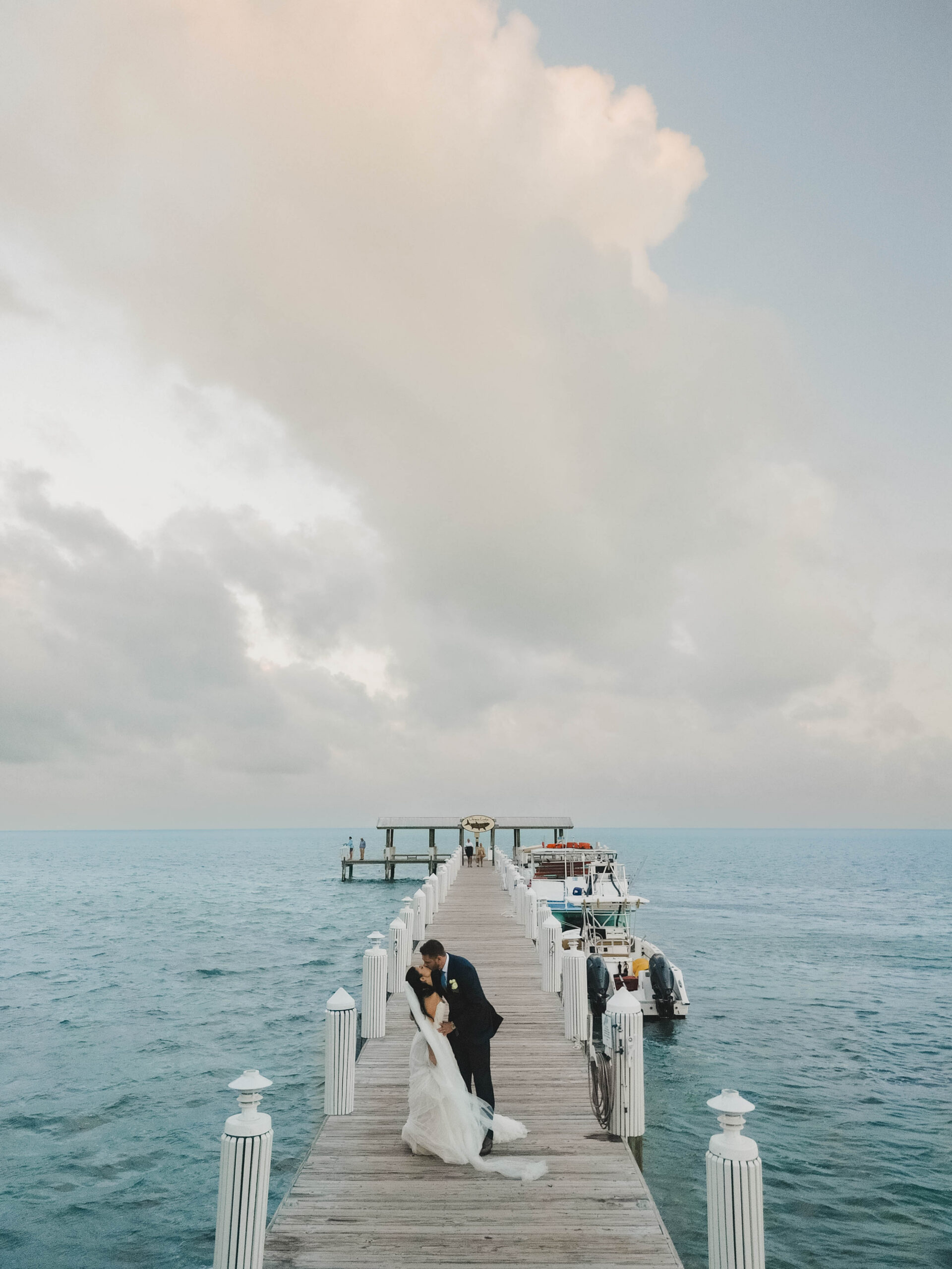 Bride and groom kissing on the pier after their Cheeca Lodge wedding ceremony