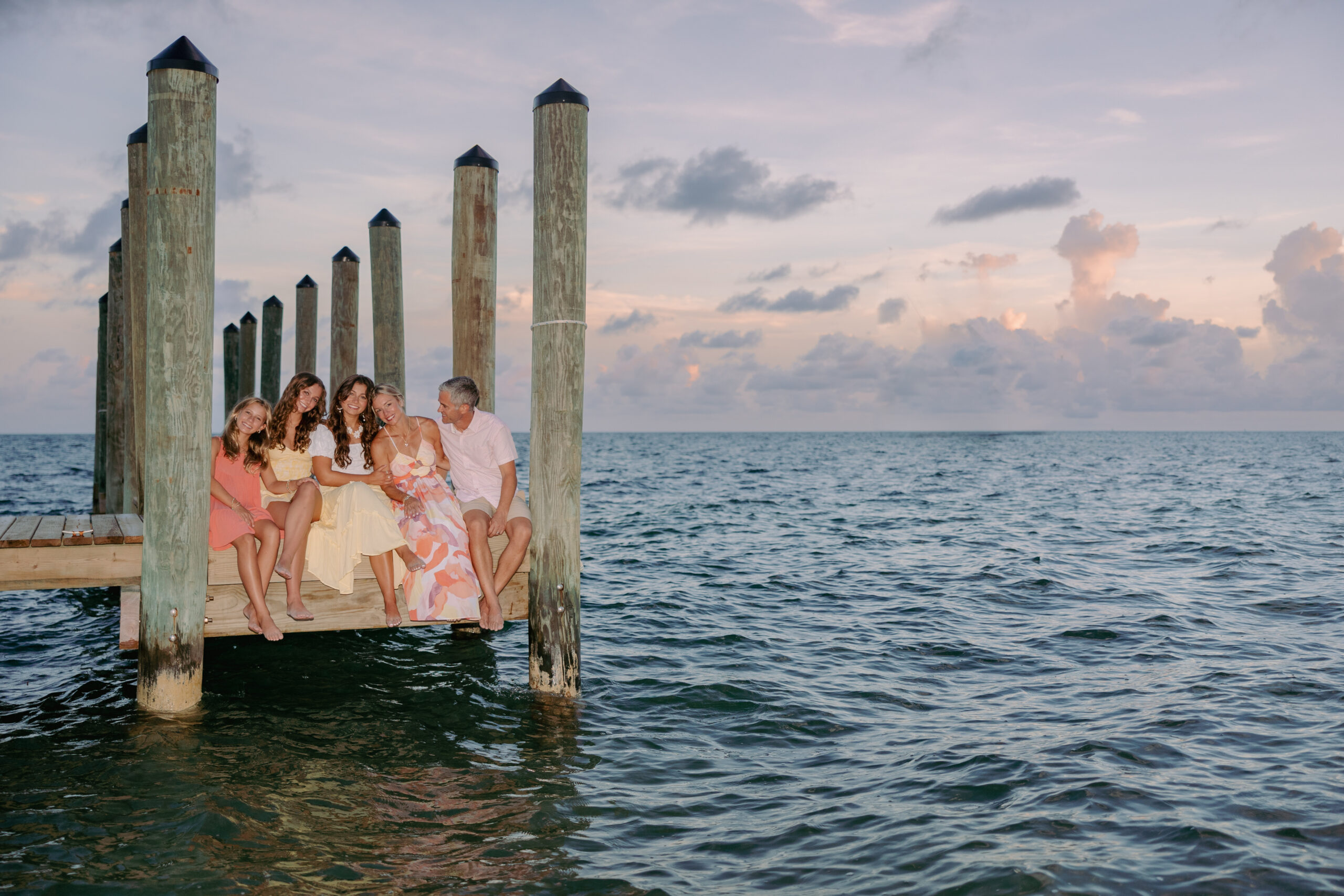 A family sitting together on a pier at a Key West resort