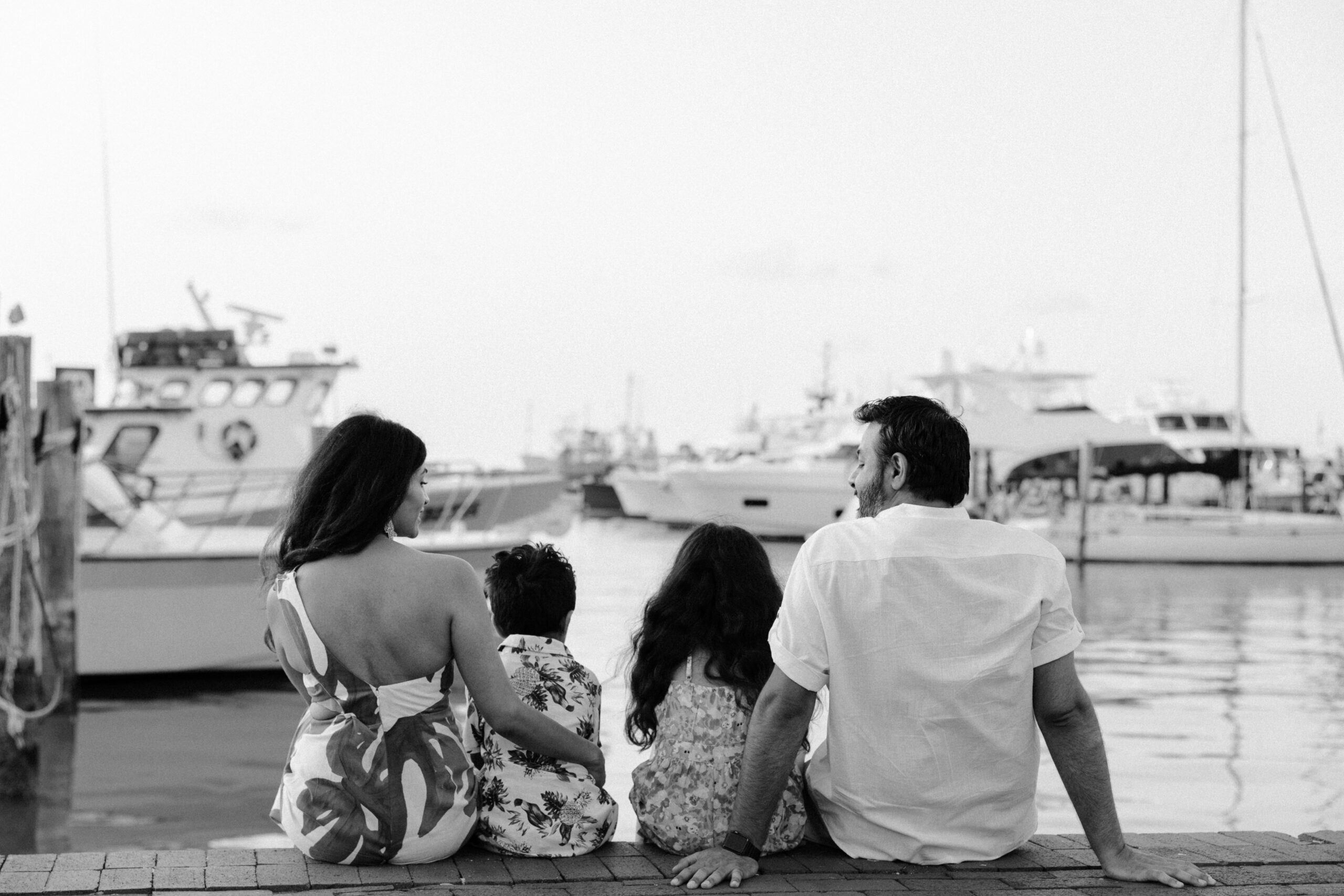 A family looking over the water and boats at a Key West marina