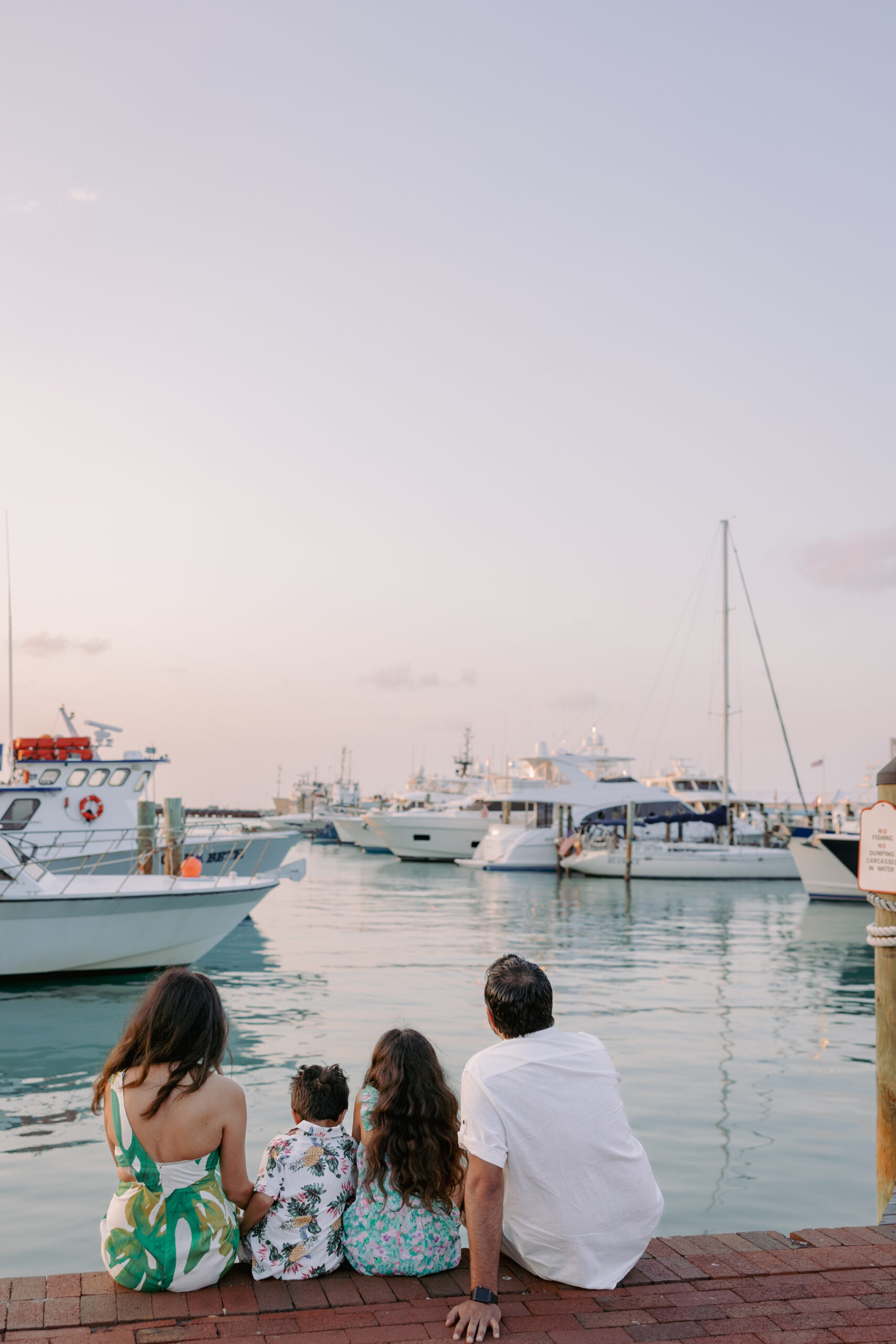 A family looking over the water and boats at a Key West marina