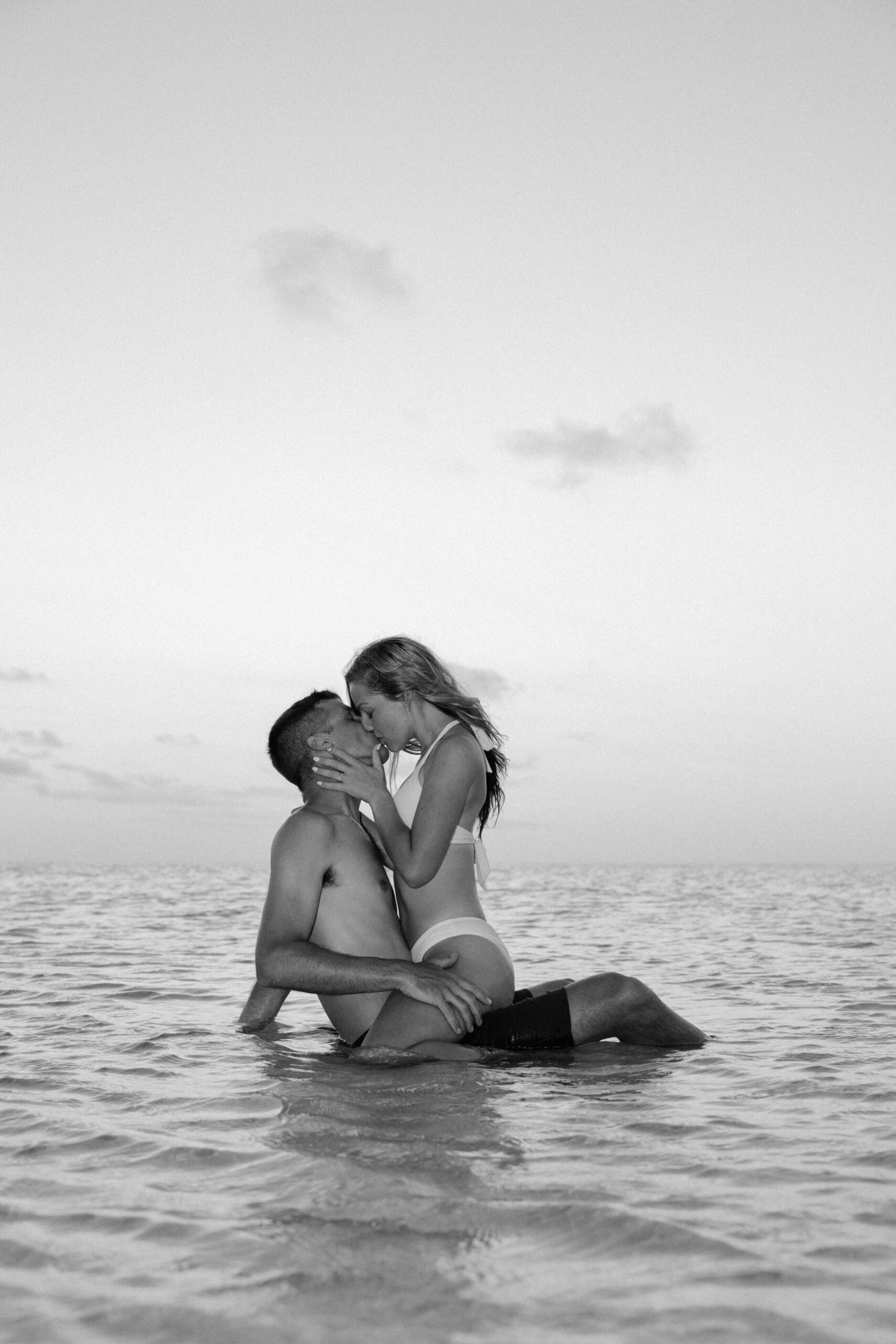 Couple kissing in the water on a beach